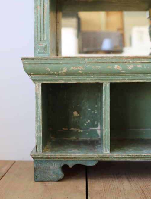A 19th-century distressed green painted glazed bookcase featuring a broken pediment, astragal glazing doors, and open lower cubby compartments. View III