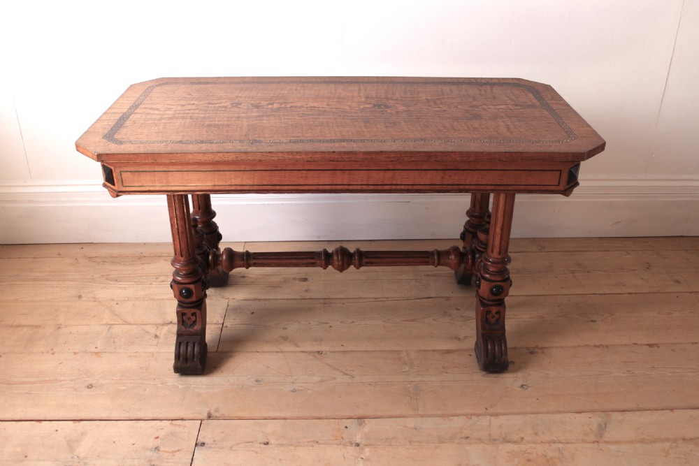A 19th-century rectangular warm brown walnut centre table featuring inlaid apron details, twin fluted column supports, and a central turned stretcher. View II