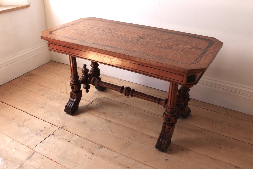 A 19th-century rectangular warm brown walnut centre table featuring inlaid apron details, twin fluted column supports, and a central turned stretcher. View III