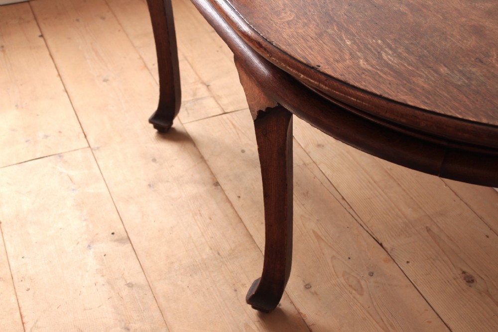 A 19th-century dark wood demi-lune table featuring a semicircular top, a low rear gallery edge, and four shaped legs. View III