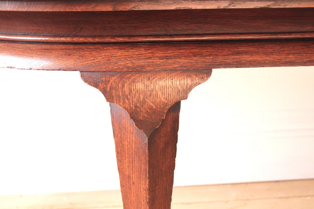 A 19th-century dark wood demi-lune table featuring a semicircular top, a low rear gallery edge, and four shaped legs. View IV