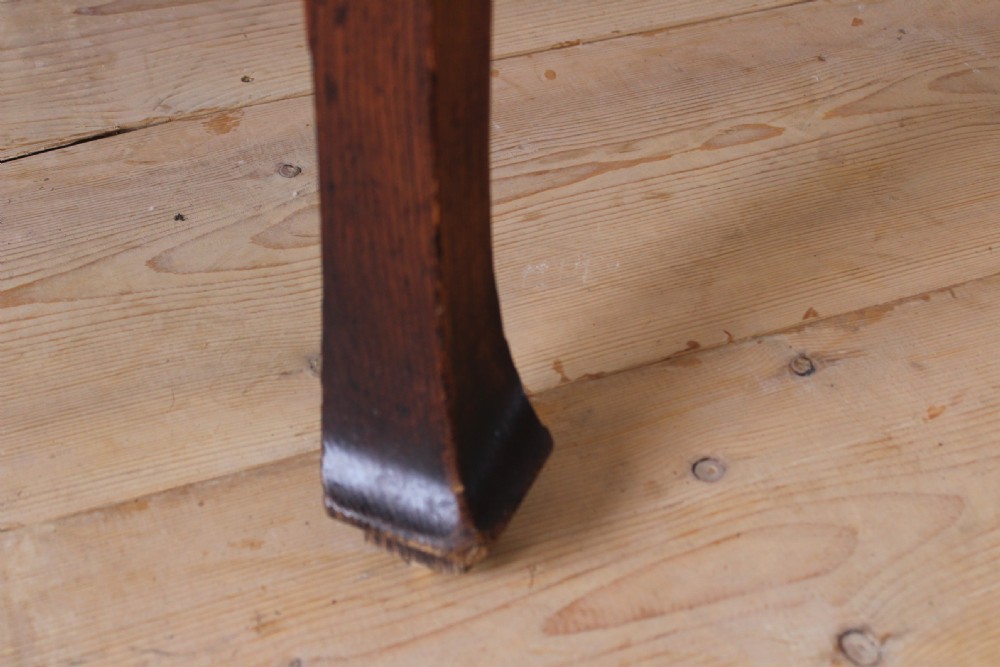 A 19th-century dark wood demi-lune table featuring a semicircular top, a low rear gallery edge, and four shaped legs. View V