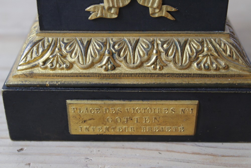 A French Empire style column table lamp made from dark metal and gilt brass with a fluted shaft, laurel wreath pedestal base, and upper shade frame. View VII