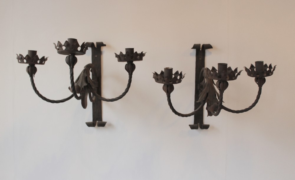 A pair of dark wrought iron Gothic wall lights featuring three twisted branches, coronet-style candle cups, and carved foliate detailing. View II