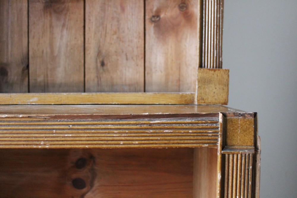 A large nineteenth-century open pine bookcase featuring three upper shelving sections set above three deeper lower compartments. View III