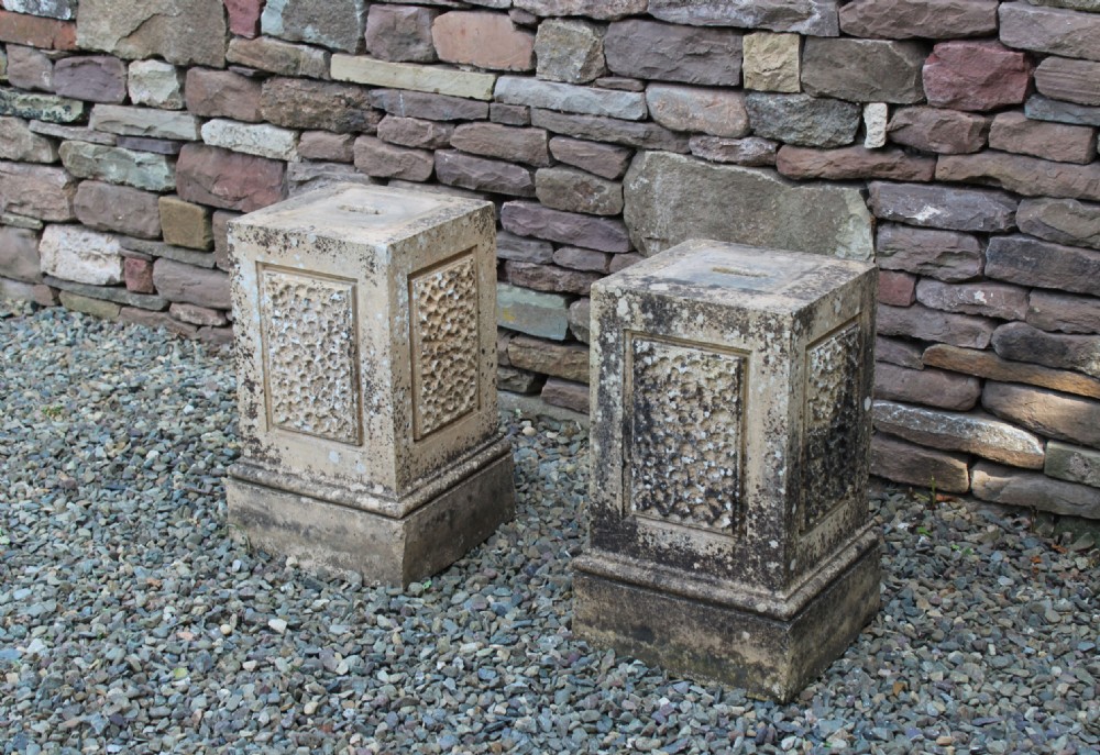 A pair of weathered nineteenth-century carved stone plinths featuring rectangular recessed panels with textured rusticated carving and moulded bases. View III
