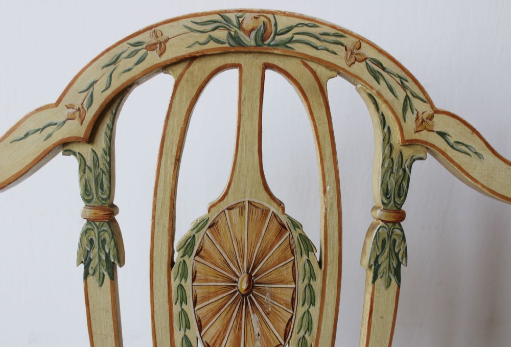 A pair of 18th-century cream painted side chairs featuring shield backs with hand-painted foliate detail and padded fabric seats. View IV
