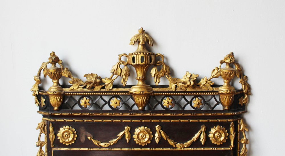An 18th-century rectangular Neoclassical wall mirror featuring an ebonised frame adorned with carved giltwood festoons, rosettes, and an ornate cresting finial. View III