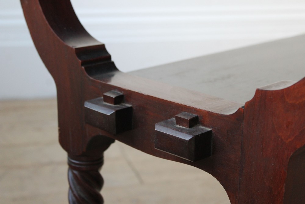 A dark mahogany Arts and Crafts console table featuring a rectangular top, an integrated lower shelf, curved side supports, and barley twist lower legs. View III