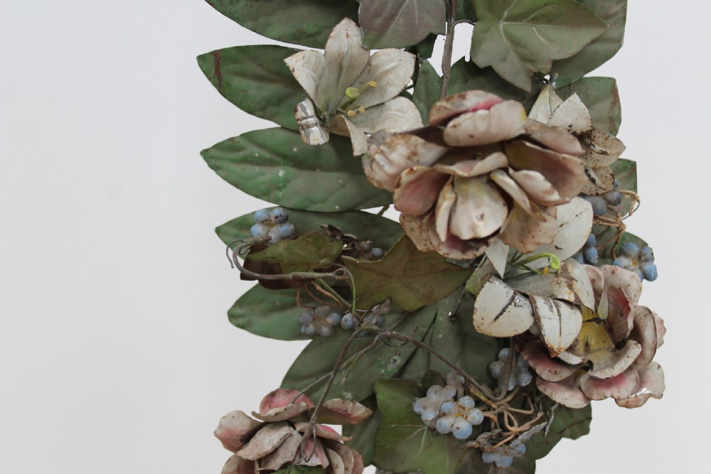 A pair of 19th-century carved cream-painted urns on square bases holding tall stems of painted sheet-metal foliage and floral blossoms. View IV