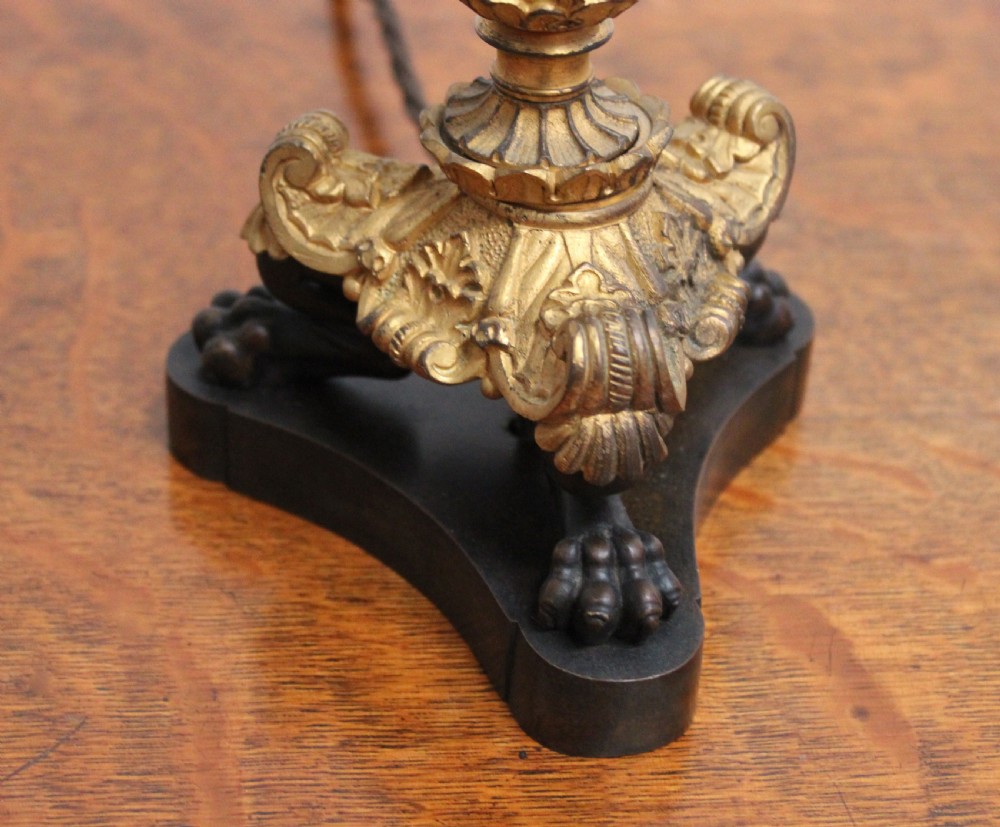 A pair of 19th-century style table lamps featuring black patinated columns with ornate gilt-bronze foliage accents and claw-footed bases. View II