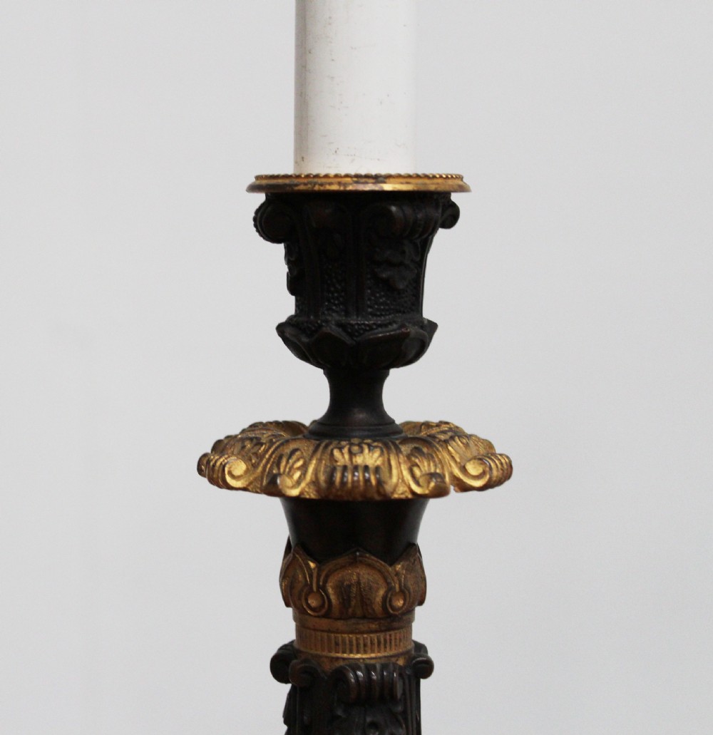 A pair of 19th-century style table lamps featuring black patinated columns with ornate gilt-bronze foliage accents and claw-footed bases. View IV
