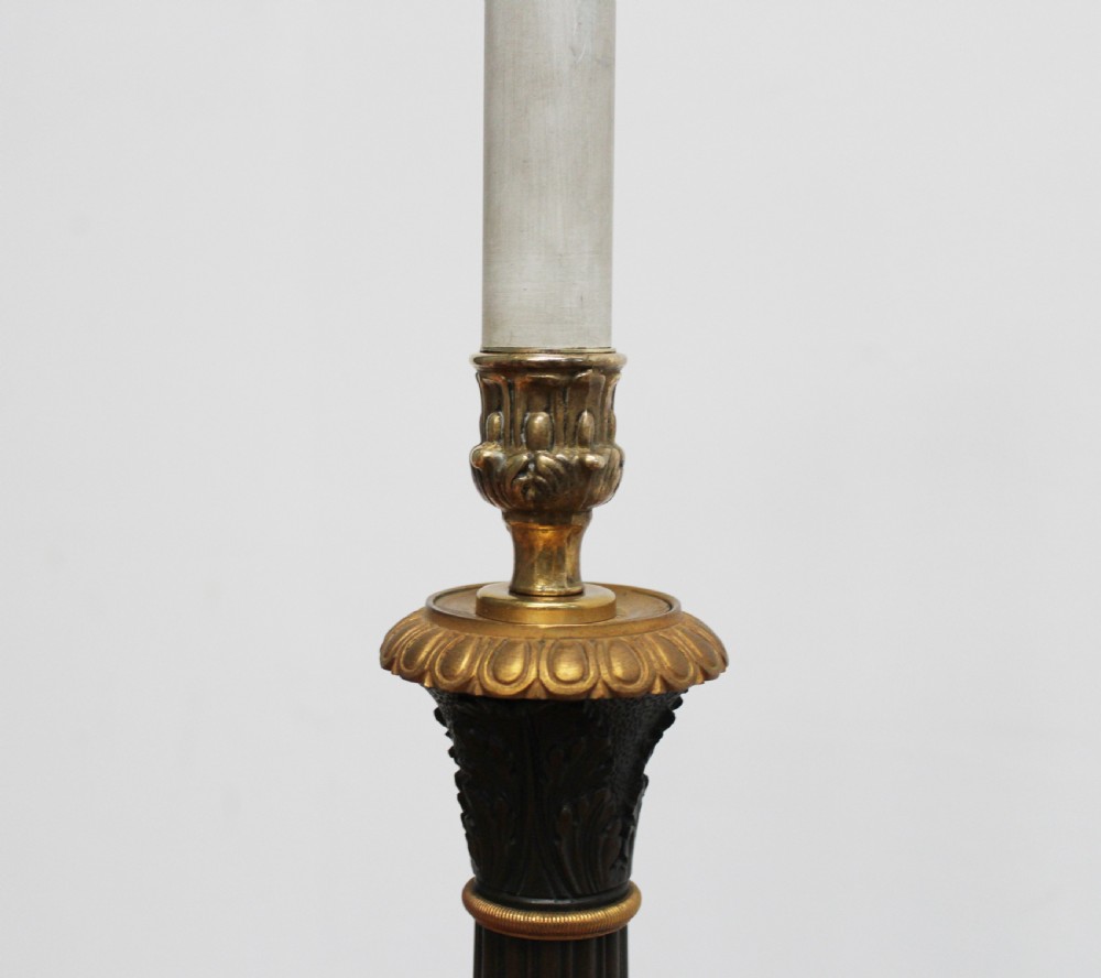 A 19th-century French Empire style table lamp featuring a dark patinated fluted column, gilt metal accents, and a triform base with paw feet. View II