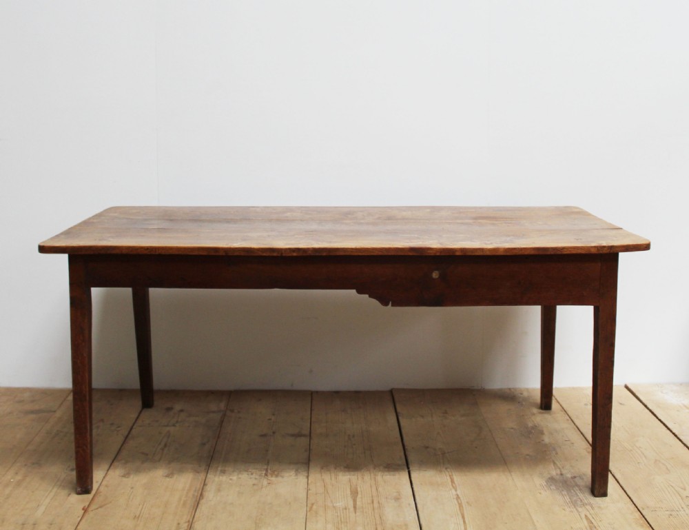 A 19th-century rustic wooden farmhouse dining table featuring a planked top, tapered square legs, and a single end drawer with wooden knobs. View II
