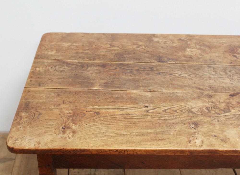 A 19th-century rustic wooden farmhouse dining table featuring a planked top, tapered square legs, and a single end drawer with wooden knobs. View III