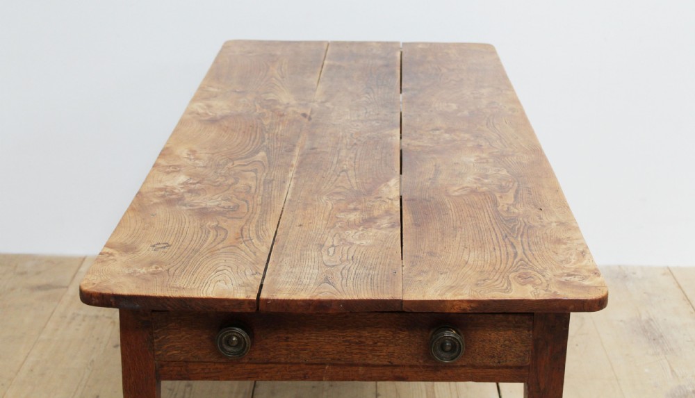 A 19th-century rustic wooden farmhouse dining table featuring a planked top, tapered square legs, and a single end drawer with wooden knobs. View IV