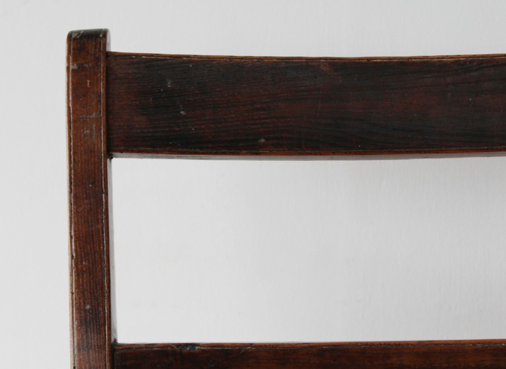A 19th-century dark wood ladder-back side chair resting on four wooden wheels. View III