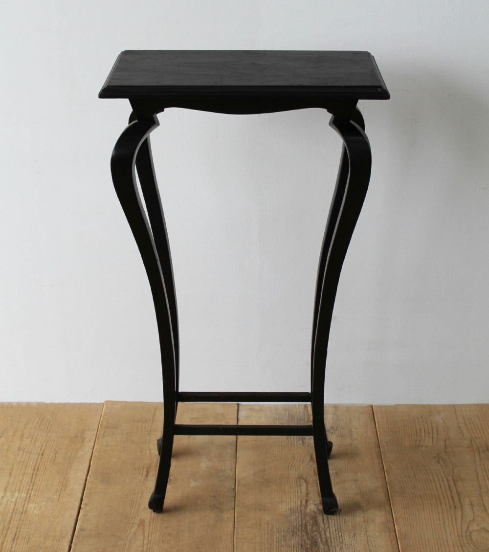 A pair of tall slender ebonised black wood console tables featuring outward-curving legs and square tops with lower stretchers. View III