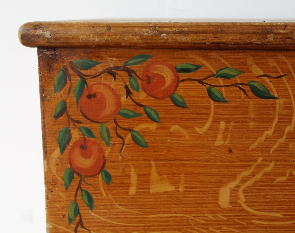 A 19th-century pine mule chest featuring two lower drawers, brass handles, bracket feet, and hand-painted fruit and leaf motifs on the front corners. View II
