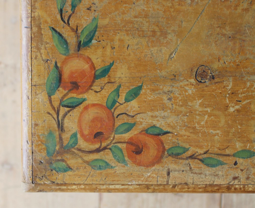 A 19th-century pine mule chest featuring two lower drawers, brass handles, bracket feet, and hand-painted fruit and leaf motifs on the front corners. View IV