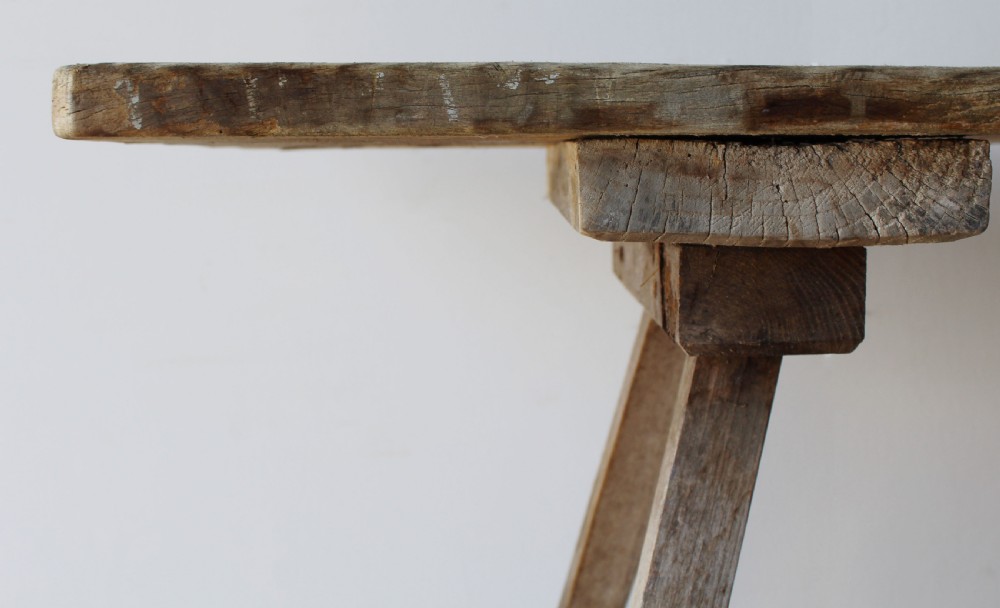 A late 19th-century rustic wooden wash table featuring splayed legs, diagonal cross bracing, and a weathered pine surface. View III