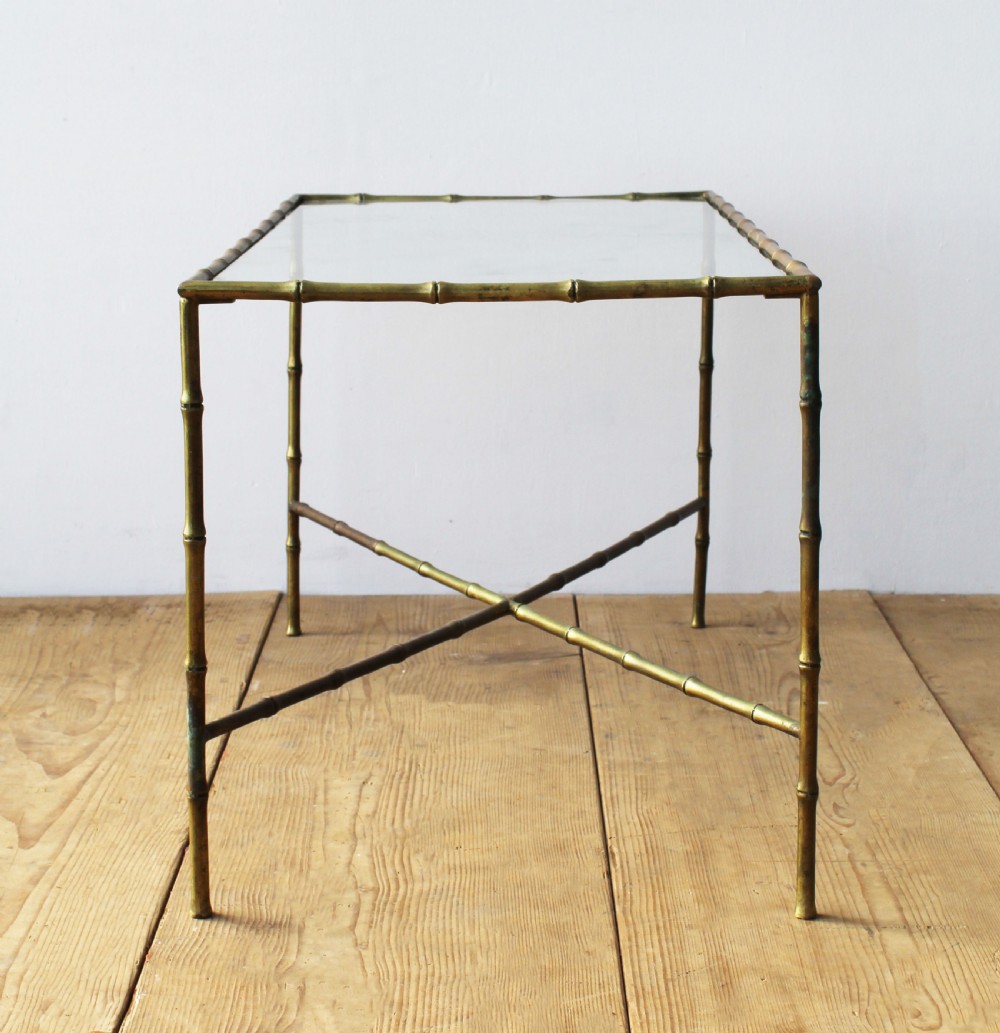 A rectangular coffee table featuring an aged brass frame designed with faux bamboo nodes, an X-shaped cross-stretcher, and a clear glass top. View II