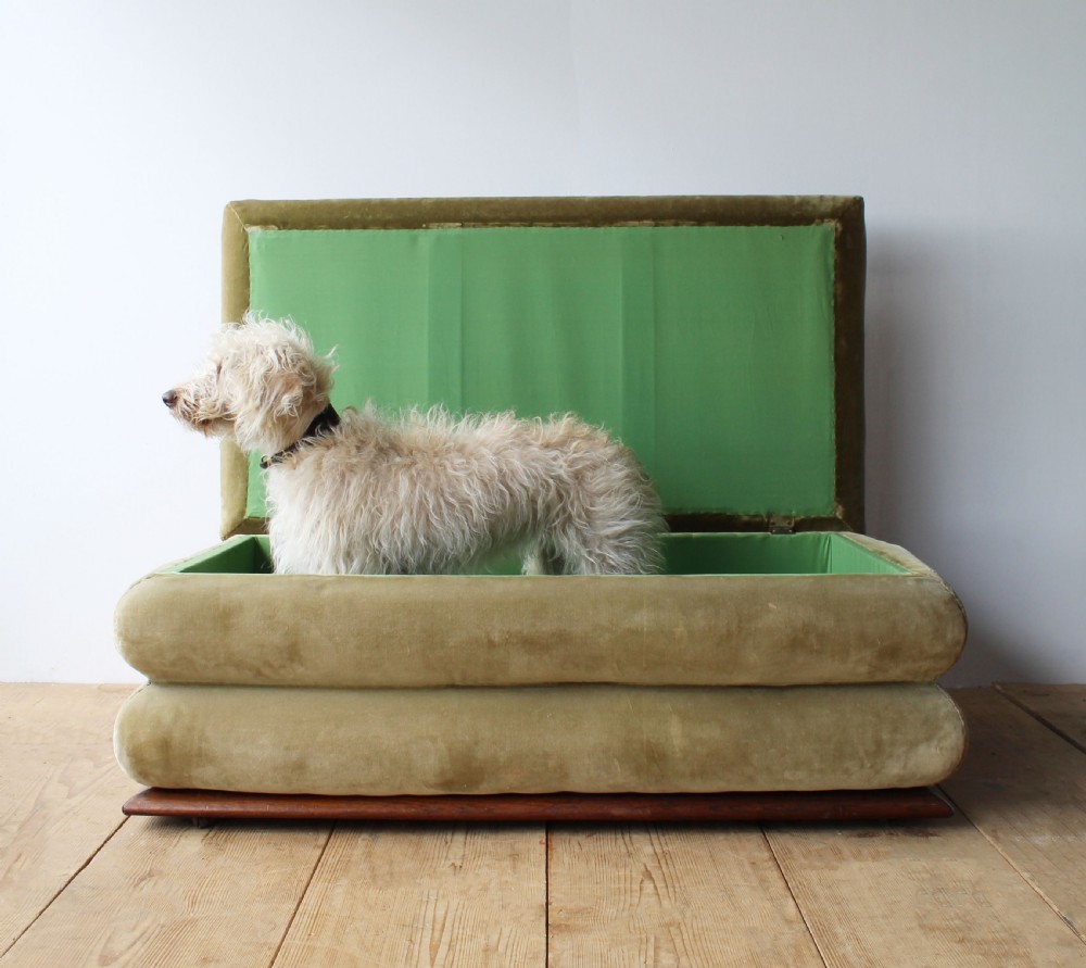 A large 19th-century tiered country ottoman with gold-green velvet upholstery, floral needlepoint top, and a wooden plinth base. View IV