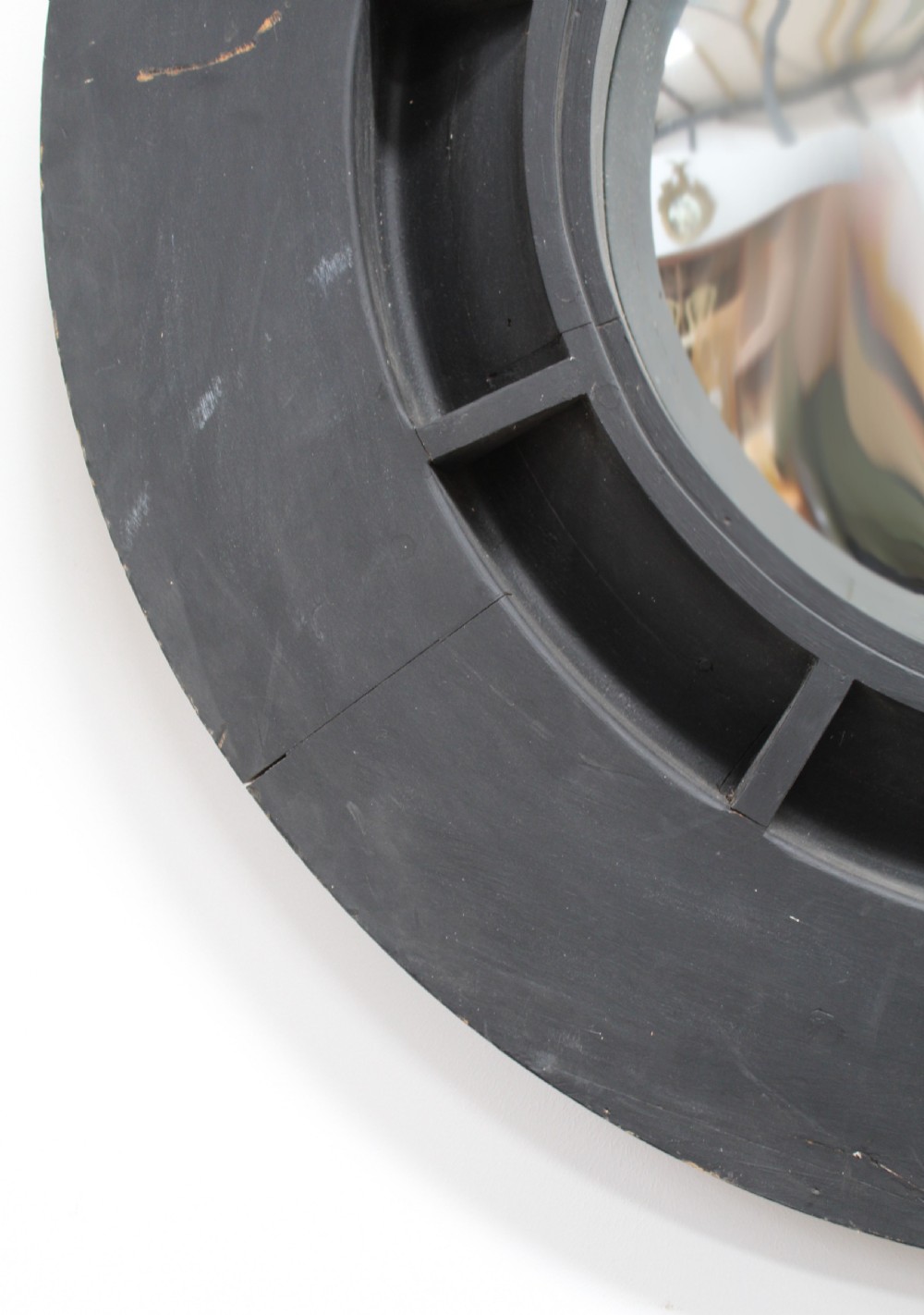 A circular ebonised wood wall mirror featuring a deep segmented frame and a central convex glass plate. View II