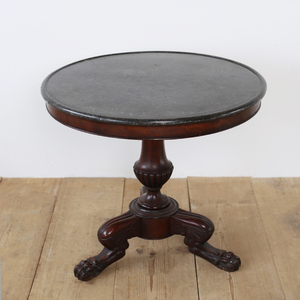 A circular Empire mahogany gueridon table featuring a dark marble top, turned pedestal stem, and carved tripod paw feet. View II