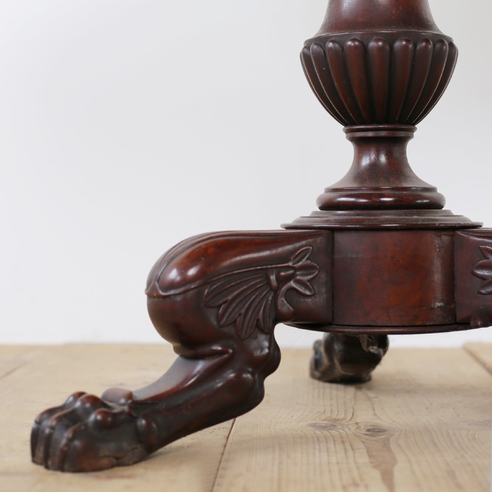 A circular Empire mahogany gueridon table featuring a dark marble top, turned pedestal stem, and carved tripod paw feet. View III