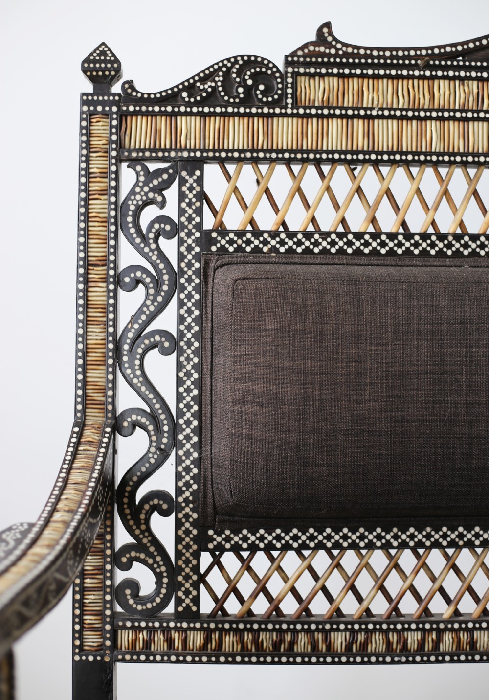 A nineteenth-century Anglo-Indian porcupine quill settee crafted from dark ebony wood with geometric bone dot inlay and dark brown fabric upholstery. View II