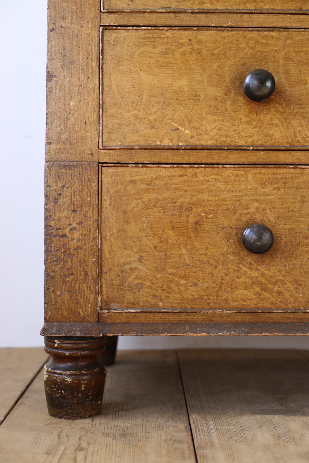 A 19th-century timber chest of drawers with turned wooden knobs and short turned feet. View III