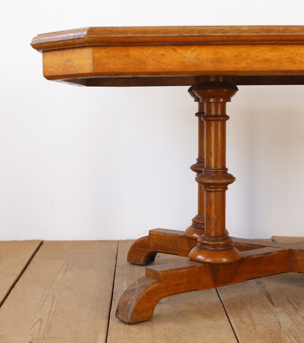 A 19th-century oak centre table featuring a canted-corner top supported by turned pillars and an X-shaped cross-stretcher base. View III