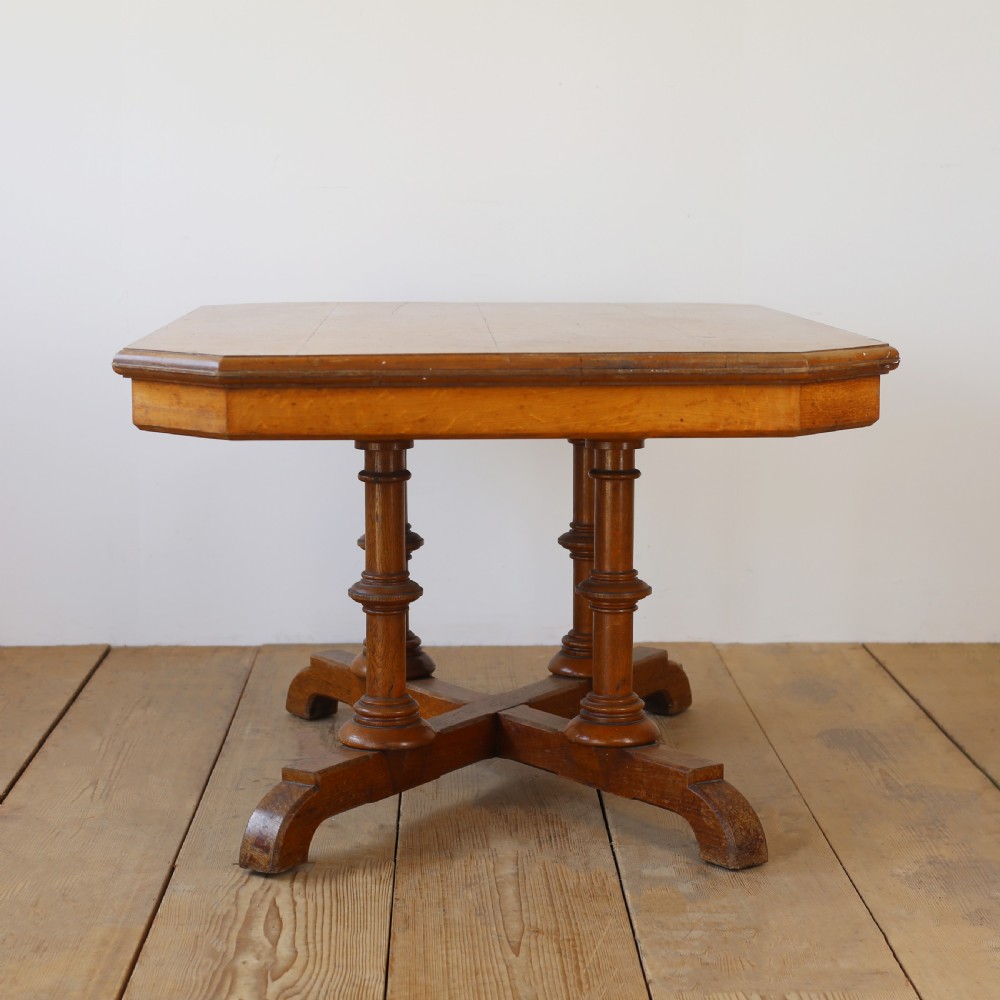 A 19th-century oak centre table featuring a canted-corner top supported by turned pillars and an X-shaped cross-stretcher base. View IV