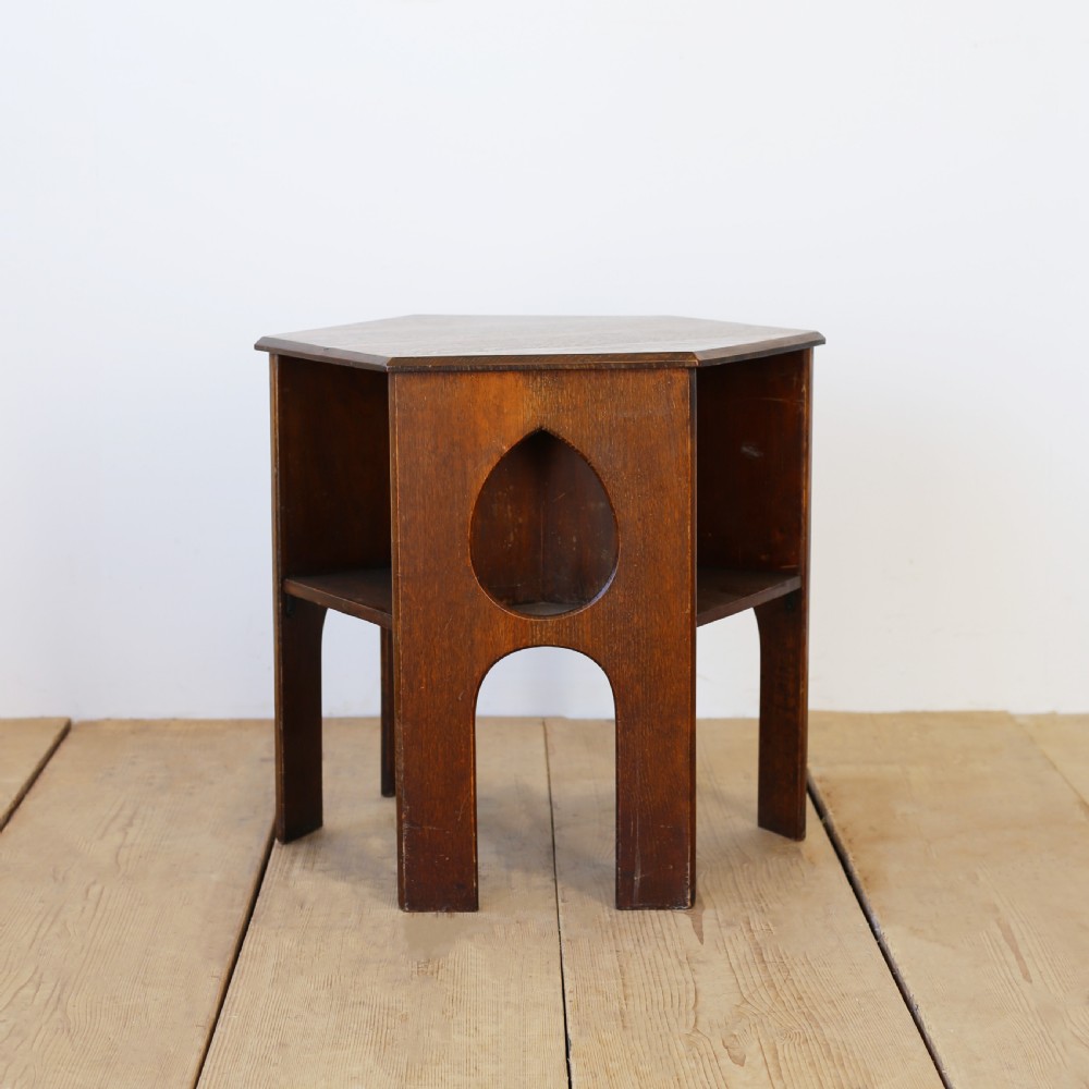A 19th-century oak hexagonal side table featuring teardrop-shaped pierced cut-outs, an open lower shelf, and straight legs.