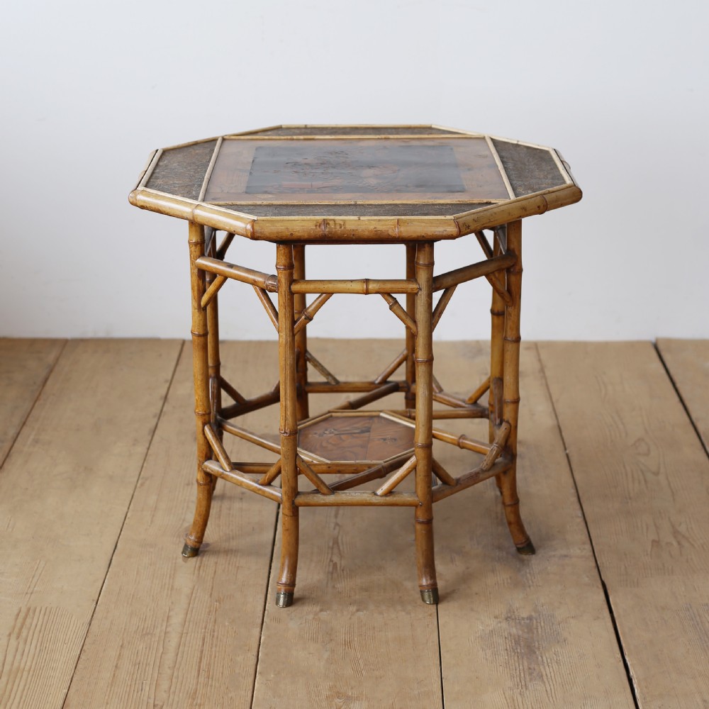 A nineteenth-century hexagonal bamboo centre table featuring bent bamboo legs, angled stretchers, a lower tier, and brass feet caps. View II