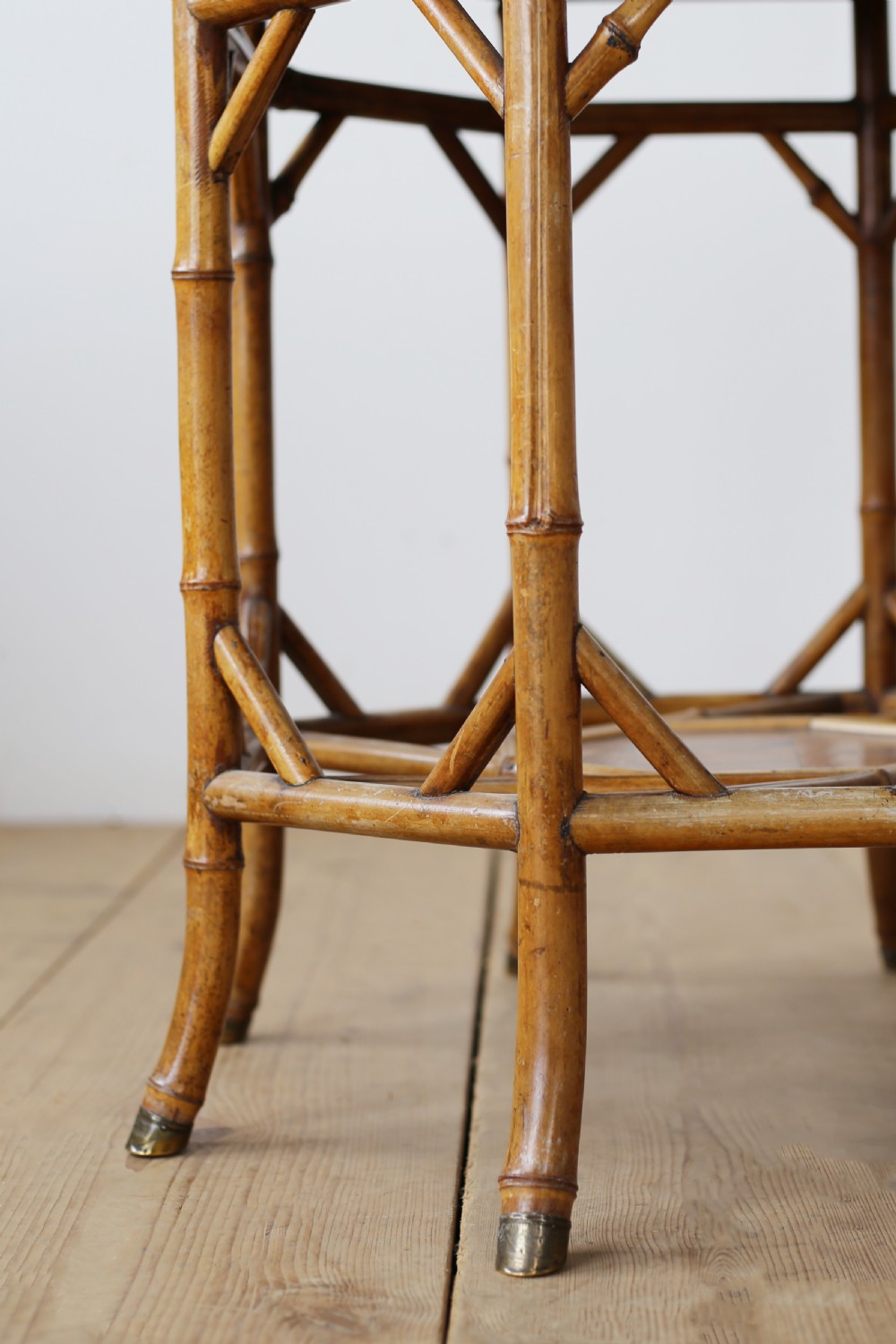 A nineteenth-century hexagonal bamboo centre table featuring bent bamboo legs, angled stretchers, a lower tier, and brass feet caps. View III