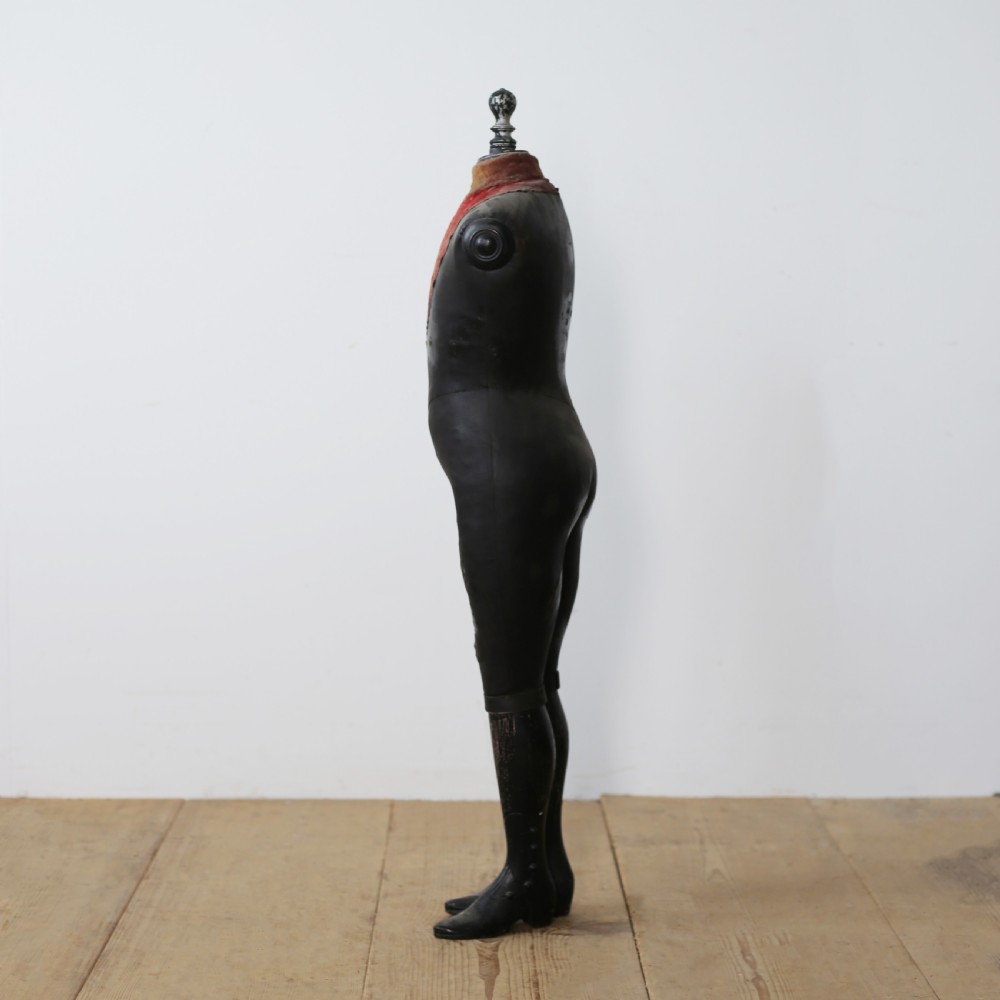 A 19th-century full-body standing tailor mannequin featuring a dark grey body with a contrasting reddish fabric chest insert and a turned top finial. View III