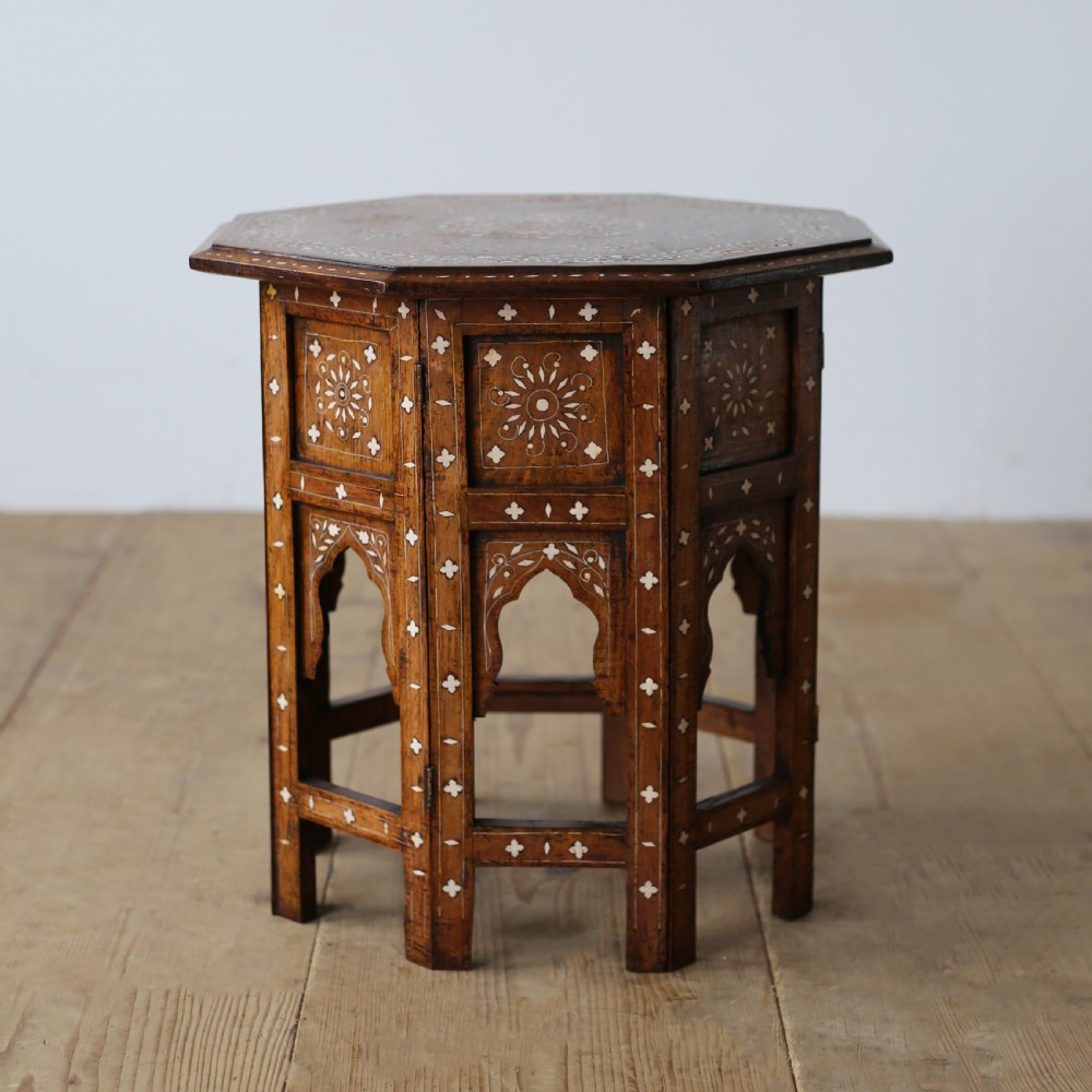 A 19th-century octagonal wooden side table with detailed white bone inlay forming floral and geometric patterns across the top and arched legs. View III