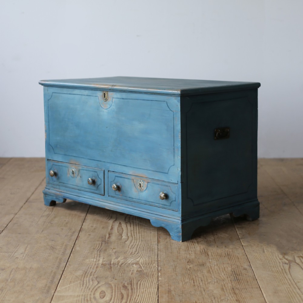 A 19th-century rustic slate blue painted wooden mule chest with a hinged lid top and two drawers with wooden knobs at the base. View III