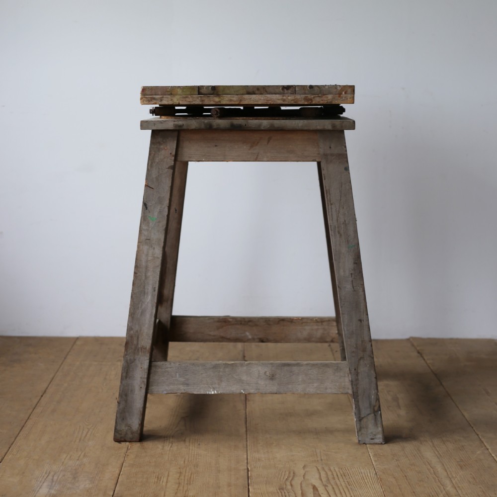 A 19th-century weathered wooden sculptors stand featuring a square revolving top supported by four tapered legs and cross-stretchers. View II