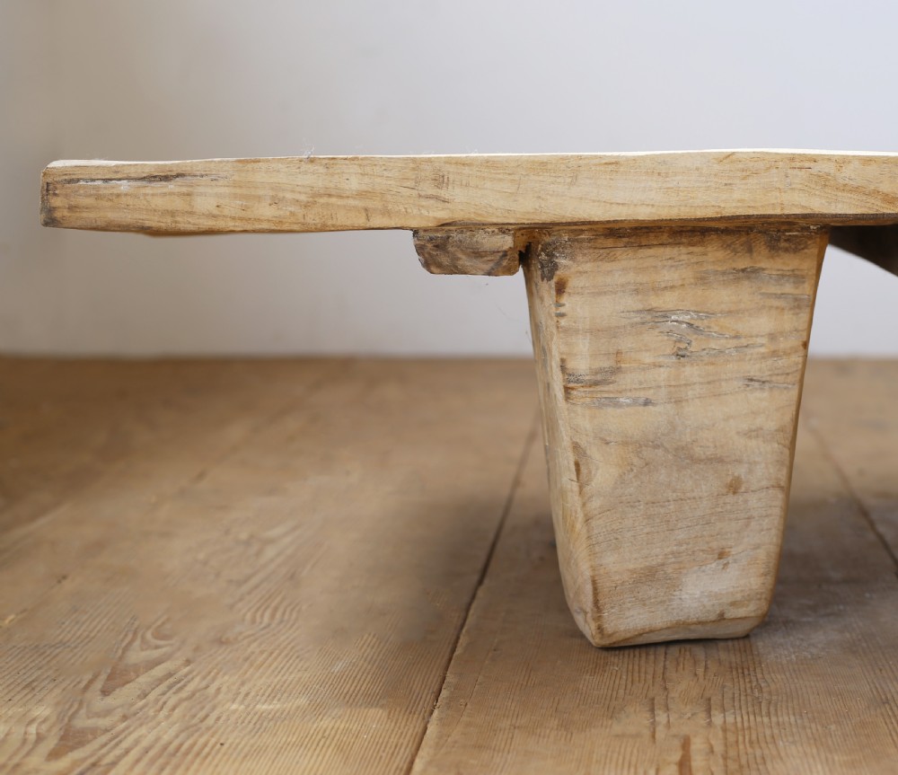 A low-slung, pale wooden Indian daybed featuring a flat rectangular timber surface resting on four heavy, tapered block legs. View II