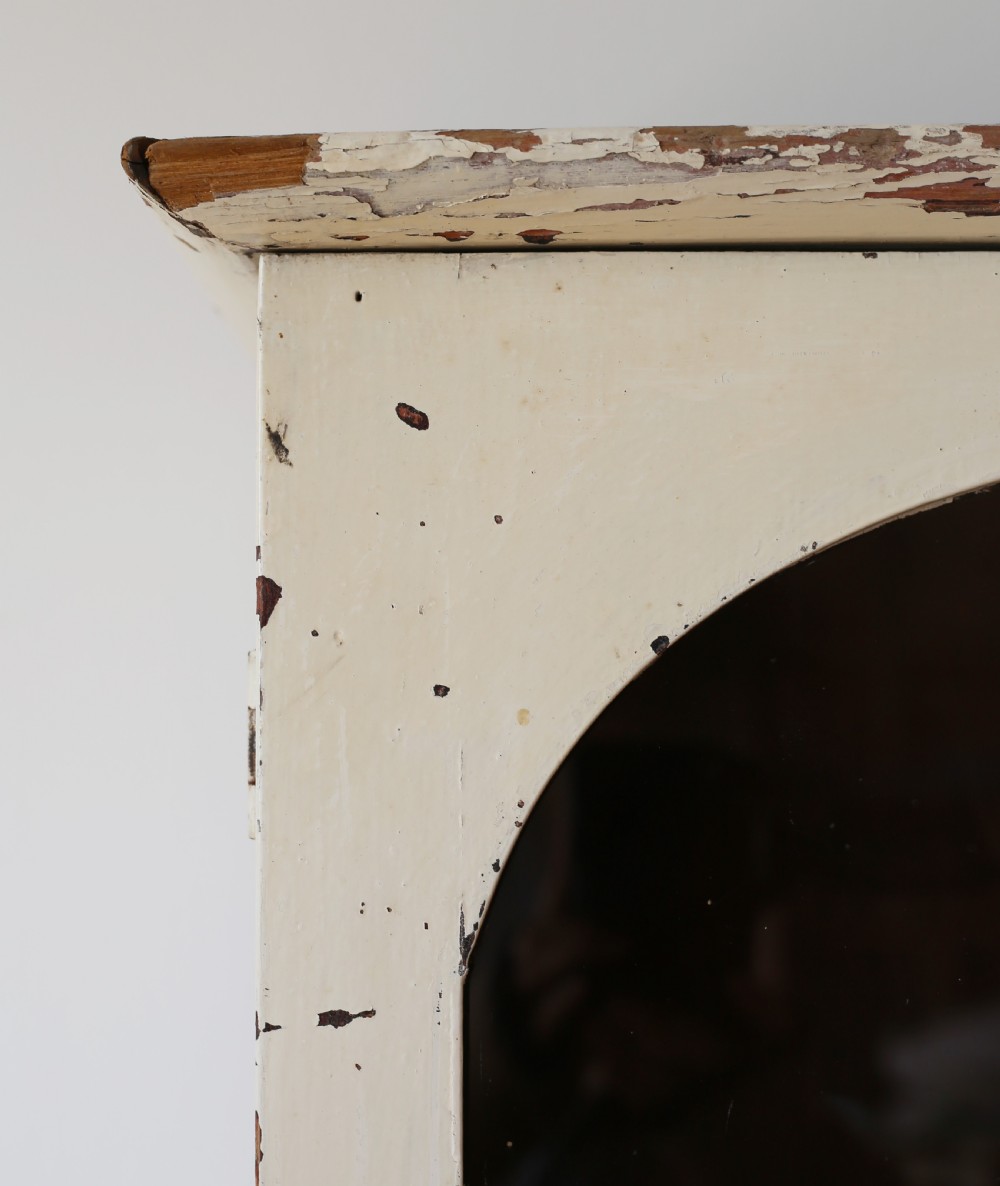 A tall 19th-century cream painted wooden cabinet featuring upper glazed doors with arched glass panels above a solid cupboard base. View III