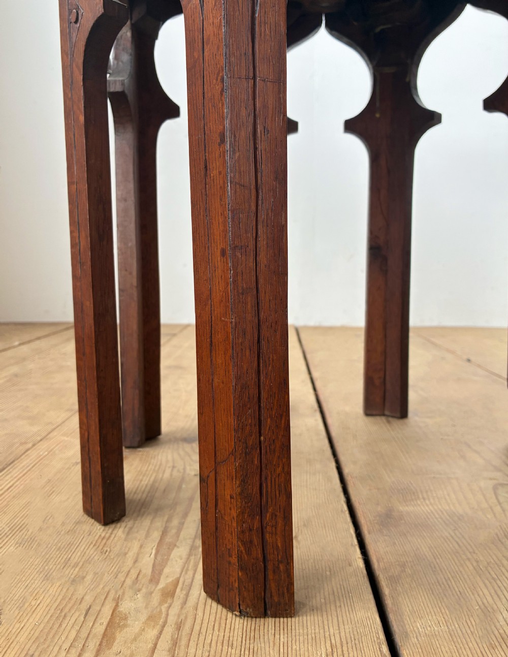 An octagonal 19th-century oak side table featuring a central carved foliate rosette top and arched Moorish revival legs. View II