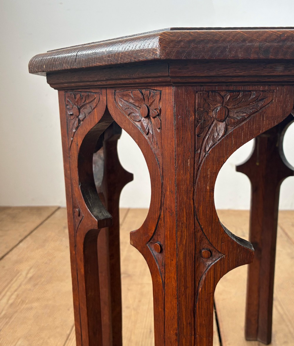 An octagonal 19th-century oak side table featuring a central carved foliate rosette top and arched Moorish revival legs. View III