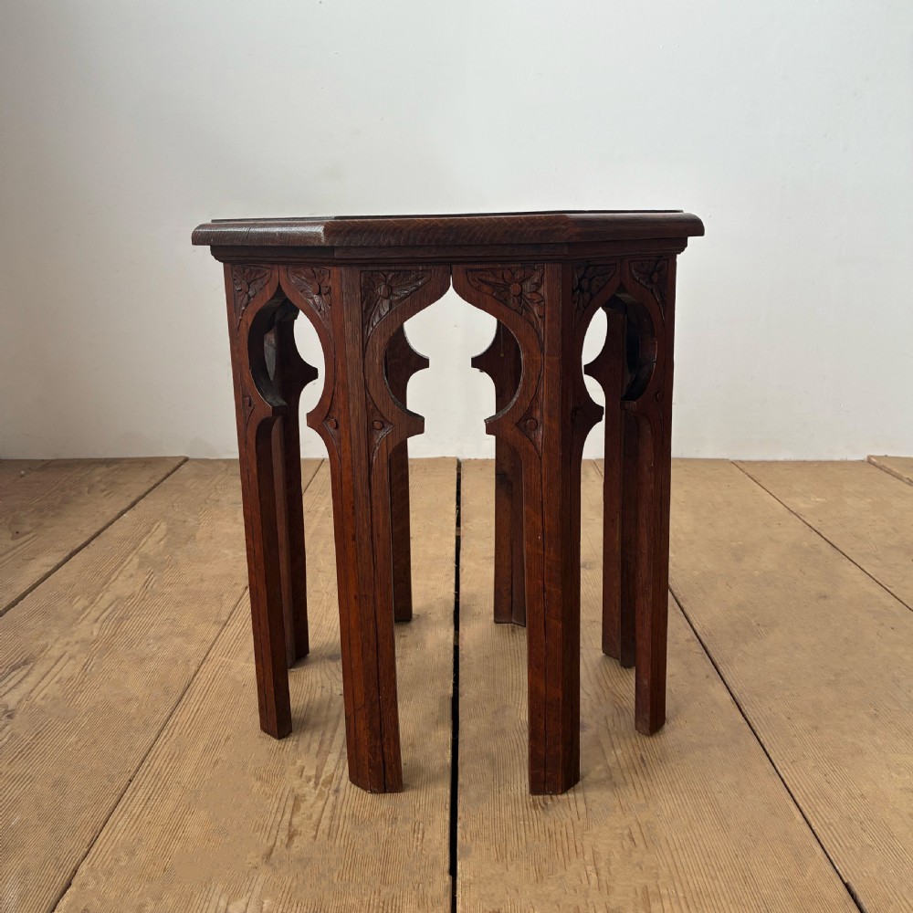 An octagonal 19th-century oak side table featuring a central carved foliate rosette top and arched Moorish revival legs. View IV