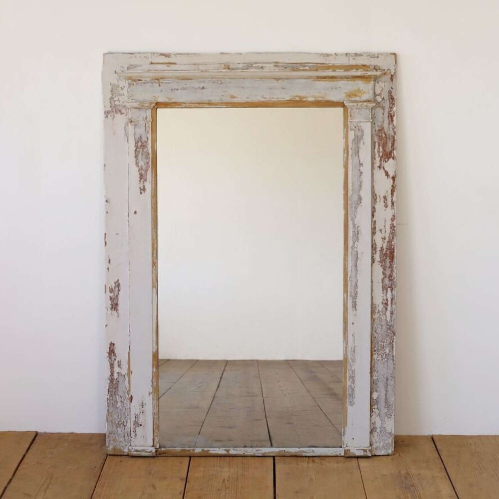 A large 19th-century rectangular mirror featuring a distressed off-white painted timber frame with architectural pilasters and a moulded top cornice.