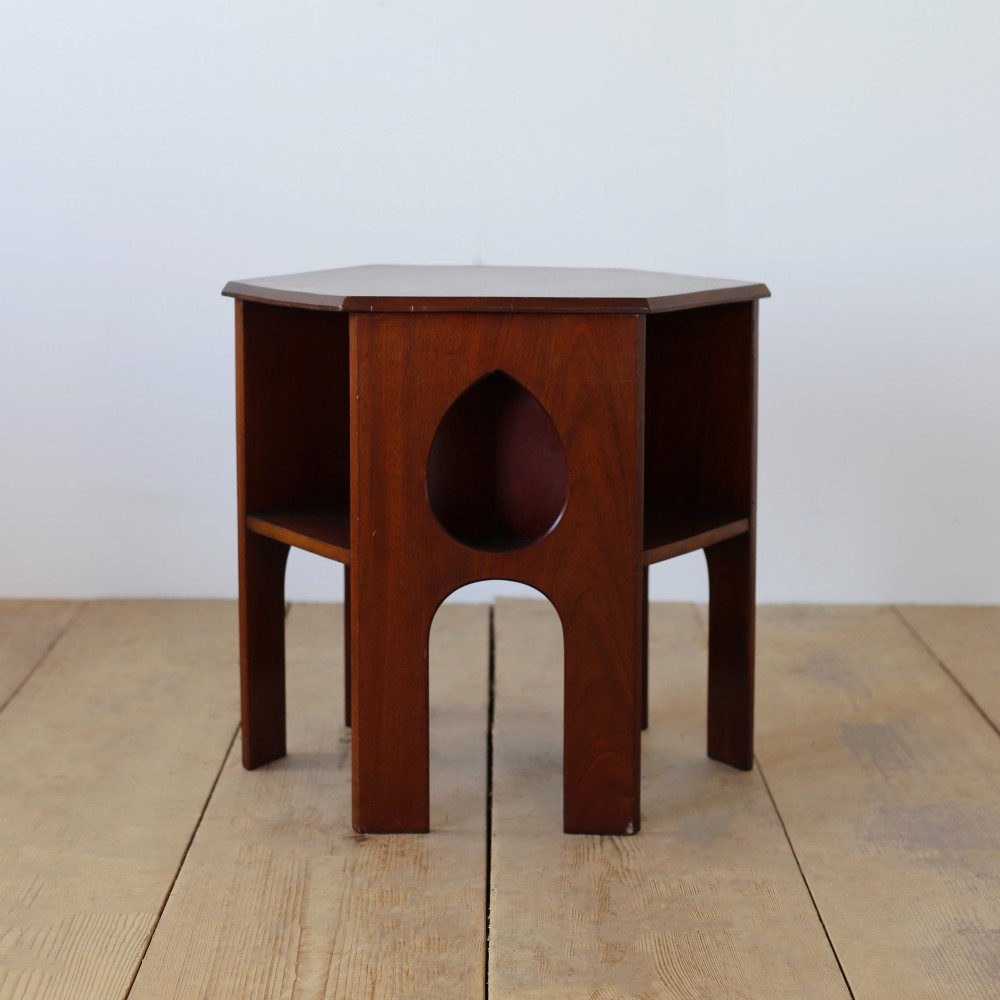 A Victorian mahogany side table featuring a hexagonal top, teardrop-shaped cutouts on the side panels, and gothic arch aprons.
