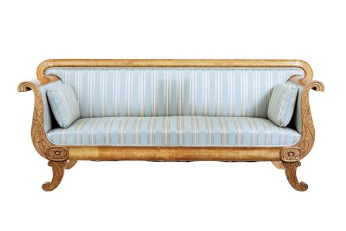 fig 1. A 19th-century Swedish carved birch sofa featuring scrolled arms, floral rosettes, swept feet, and light blue and white striped upholstery.