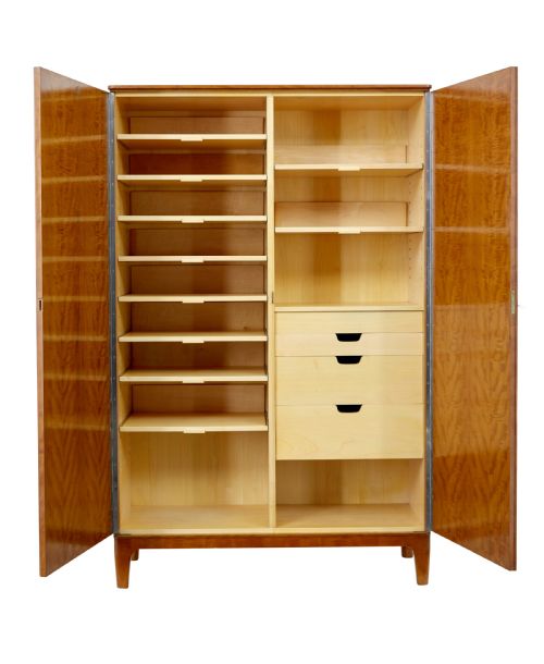 fig 2. A mid-century modern double-door wardrobe crafted from figured golden birch wood with short tapered legs.